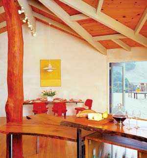 The large, open great room leads onto an expansive elevated deck, adding outdoor living space with easy access to the kitchen.